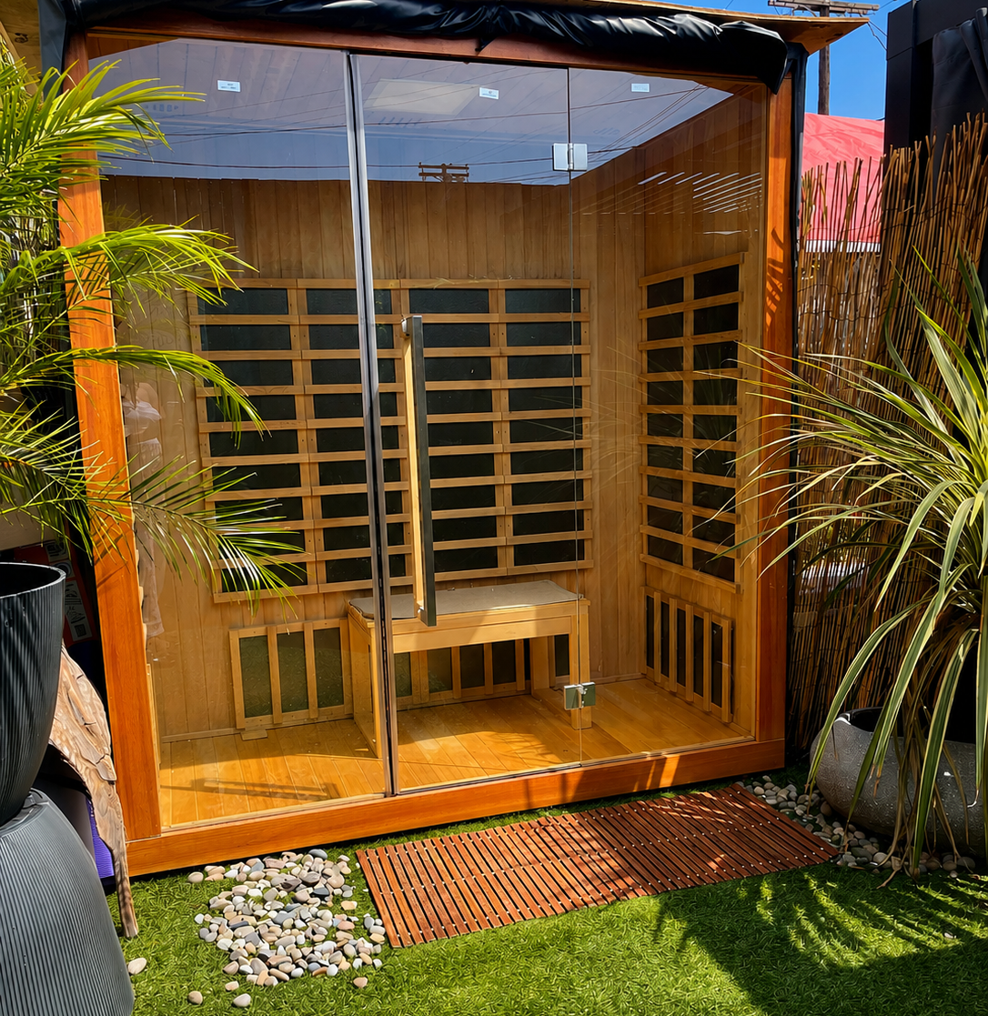 The outdoor infrared sauna at Queen By Nature, with its glass door and cedar interior